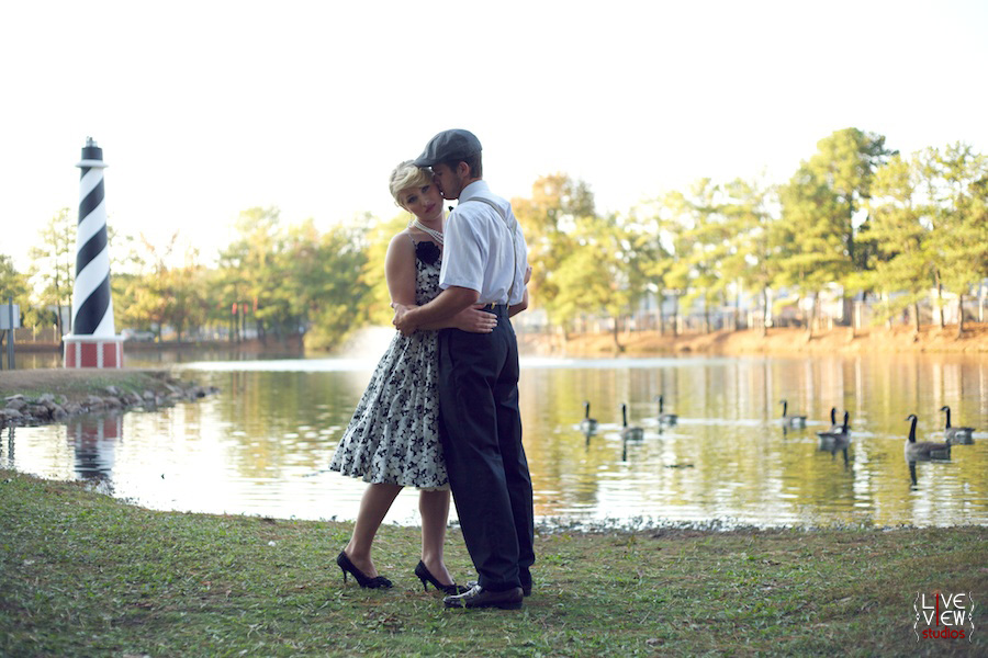 couple hugging, lake and lighthouse at the fair