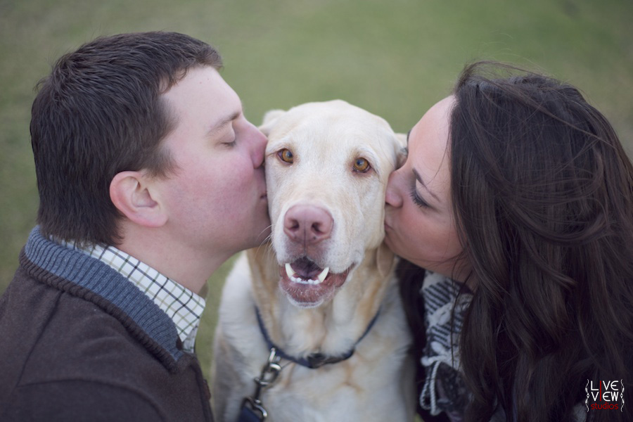 couple kissing dog during engagement photos, outer banks nc