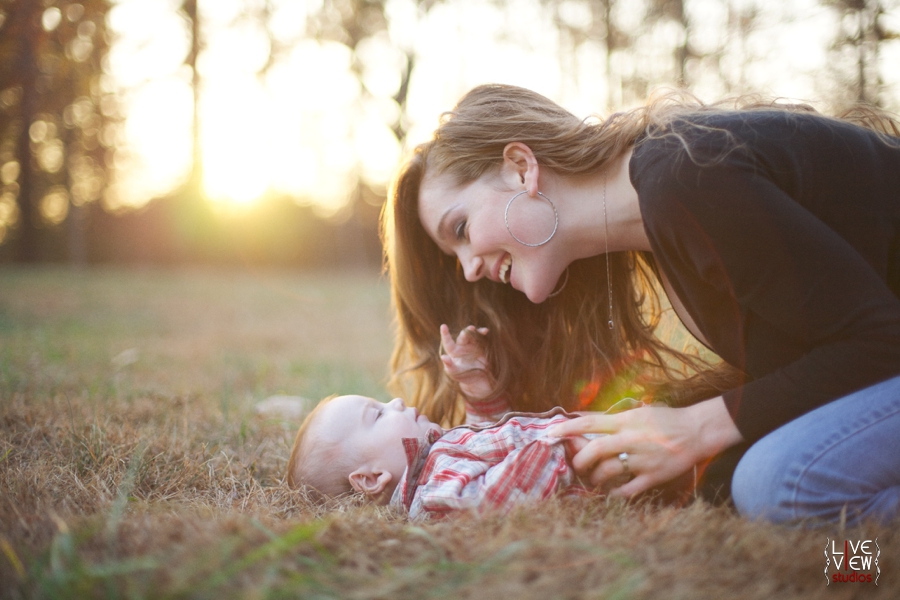 mother smiling at baby in sunlight, baby photography nc