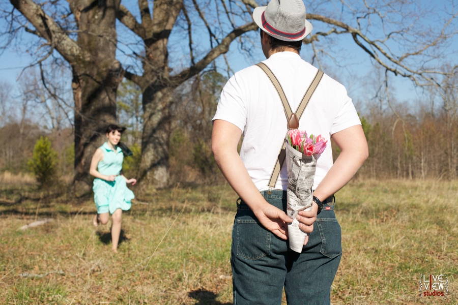 romantic retro couple's photography, man holding flowers wrapped in newspaper for his love