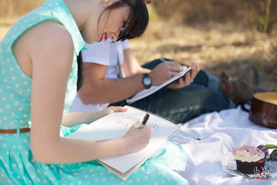 lovers write notes to each other at a valentine's day picnic, raleigh nc engagement photographers 