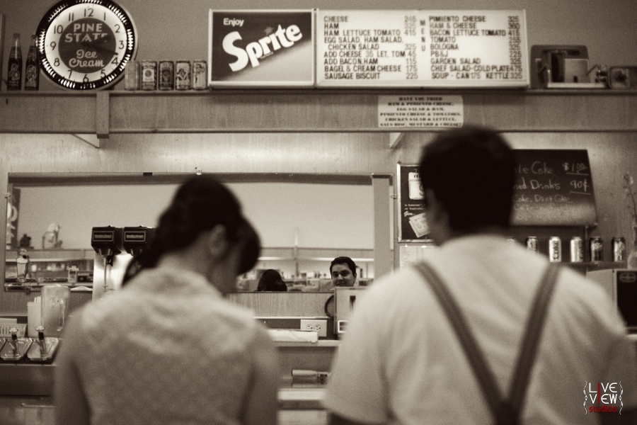 a young couple waiting at elliotts pharmacy, retro engagement photography 