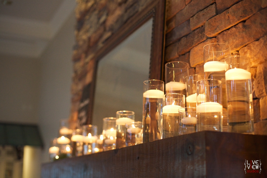 candles burning on the fireplace mantle at piazza at portofino, raleigh nc wedding photography
