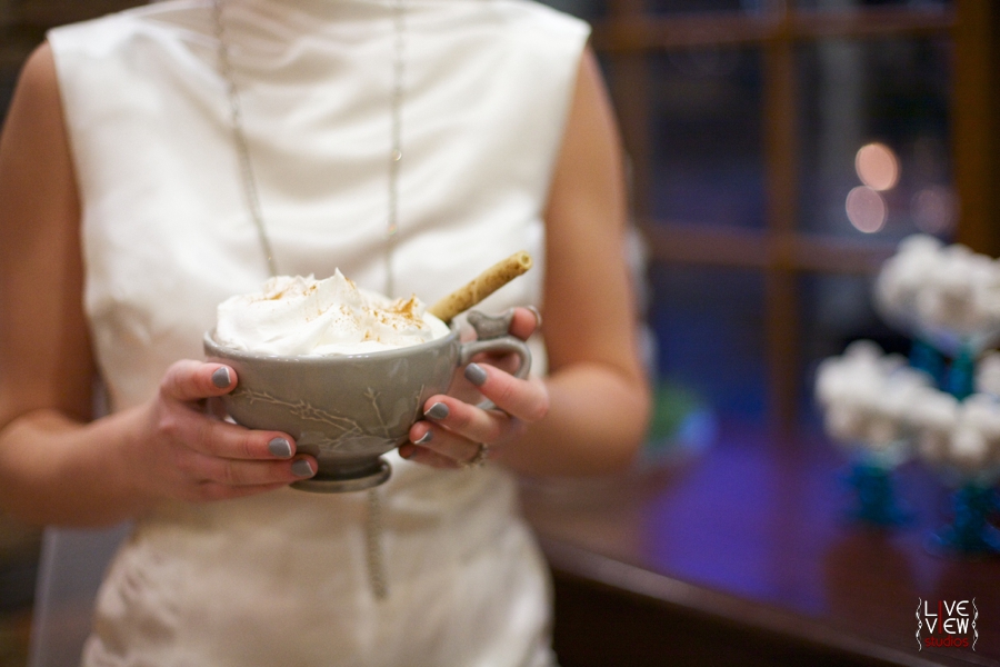 bride holding a mug of hot cocoa topped with whipped cream, winter wedding inspiration