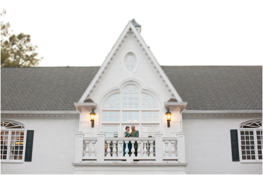 bride and groom smile at guests from a balcony , southern weddings