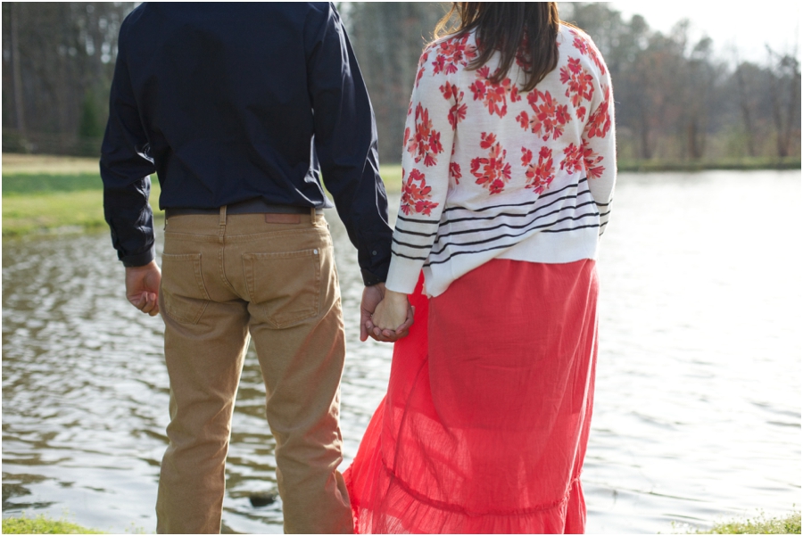 couple holding hands by the lake at cloer vineyards, southern engagement photographers, raleigh nc