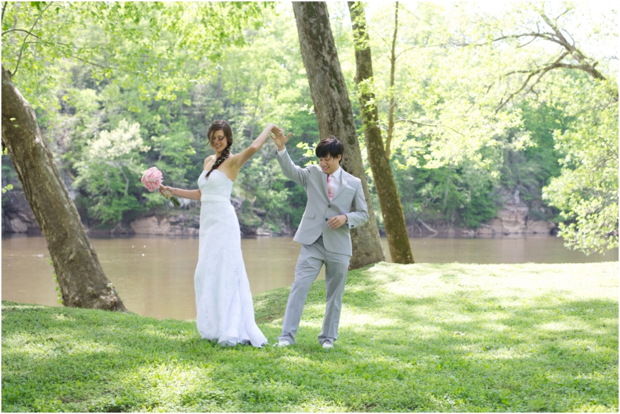 bride and groom dancing by a river, romantic first look photography