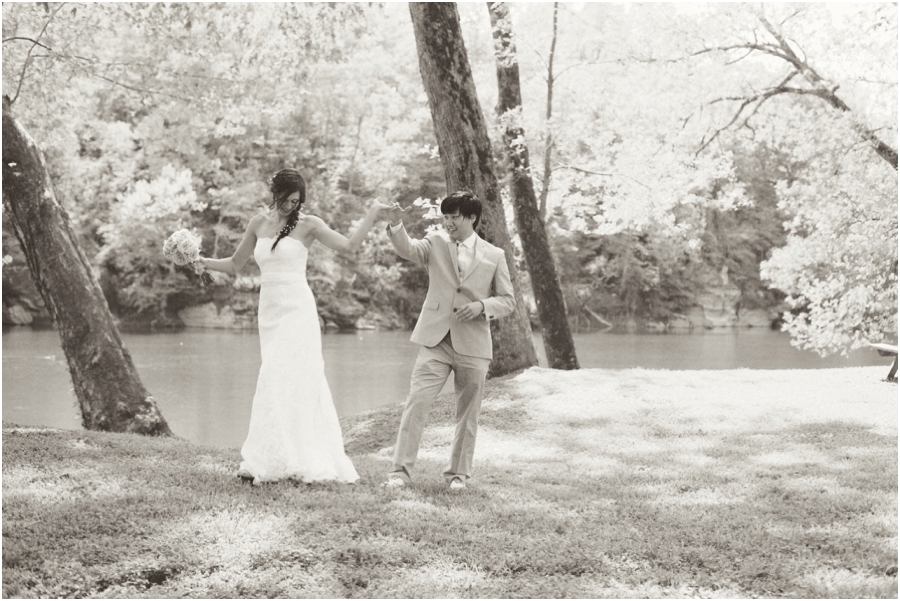 beautiful black and white wedding photography, bride and groom dancing by the riverside