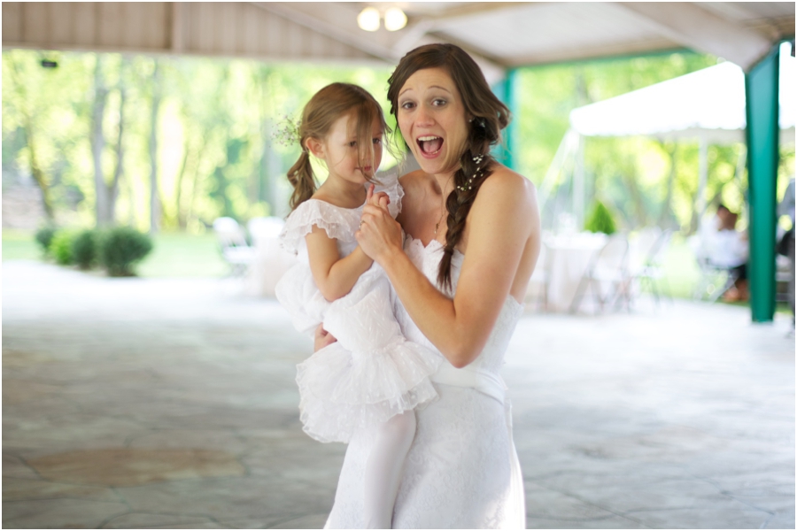 bride dancing with flowergirl, rustic spring wedding photography