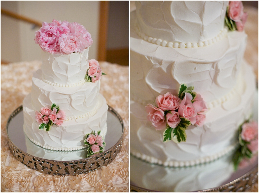 elegant strawberry buttercream wedding cake with fresh pink flowers from Maxie B's Bakery , pearl details on elegant wedding cake