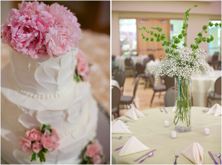 creamy wedding cake decorated with fresh pink flowers, tall floral table centerpieces at wedding reception