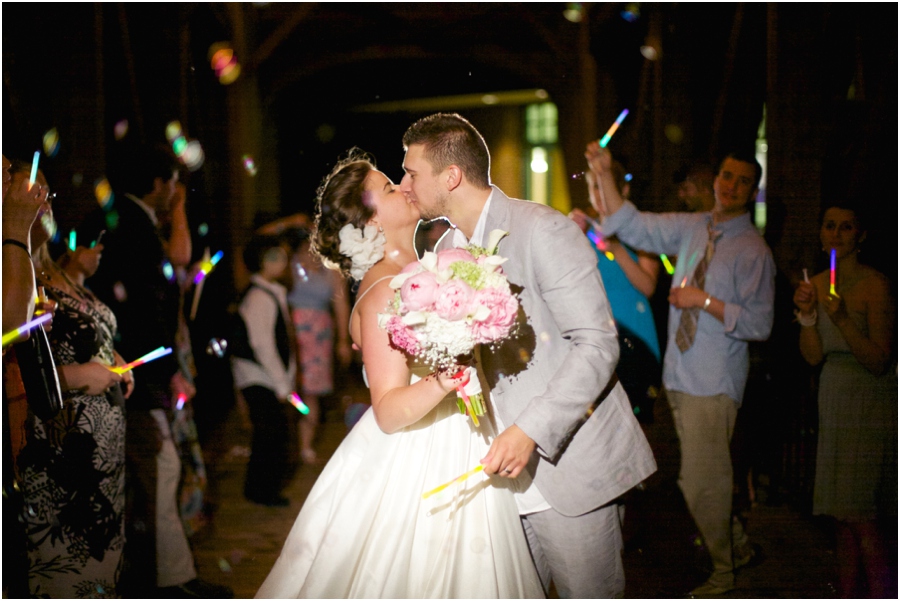 bride and groom exiting to a fun glowstick and bubble sendoff, winston salem nc wedding photographers