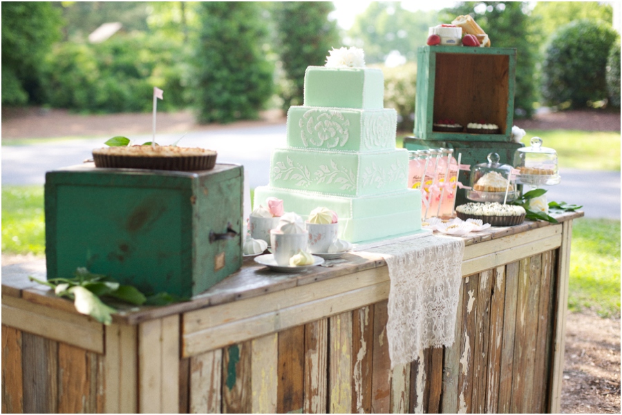 reception bar laden with mini and full-size pies, colorful meringues in vintage tea cups, assorted sweets, and a gorgeous mint and lace cake designed by Linacucina 
