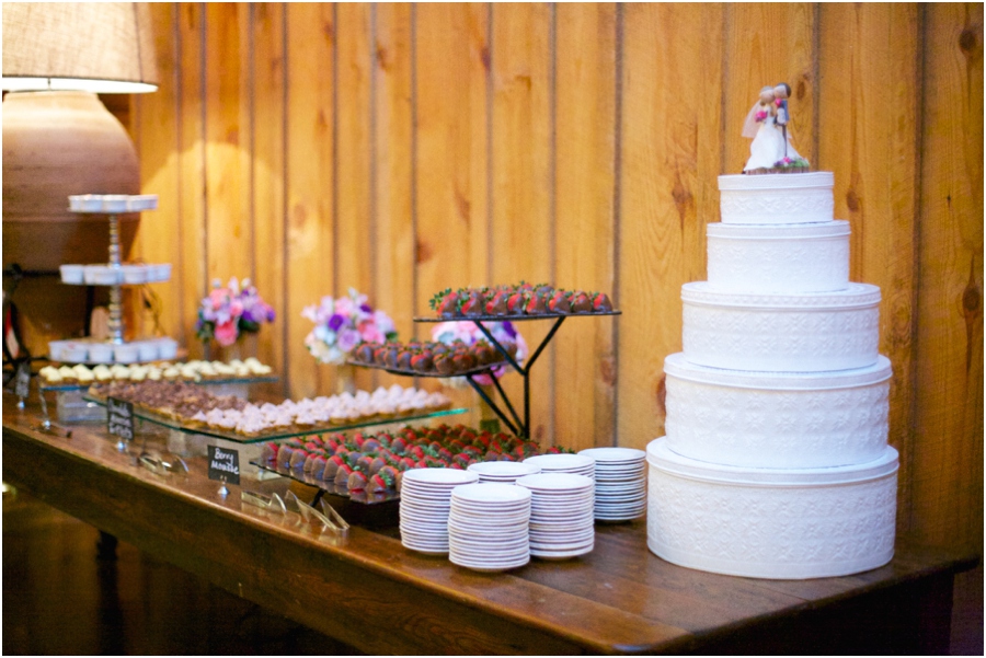 stacked vintage tins and a cute topper in lieu of a traditional wedding cake, chocolate covered strawberries, small tartlets, creme brulee, and other small treats on the dessert table