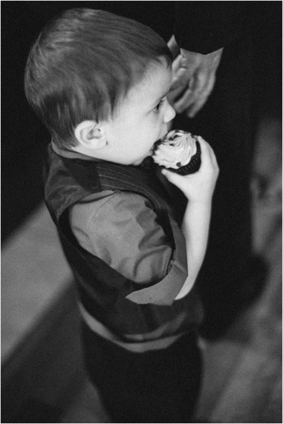 little boy taking a bite of his cupcake at southern wedding reception