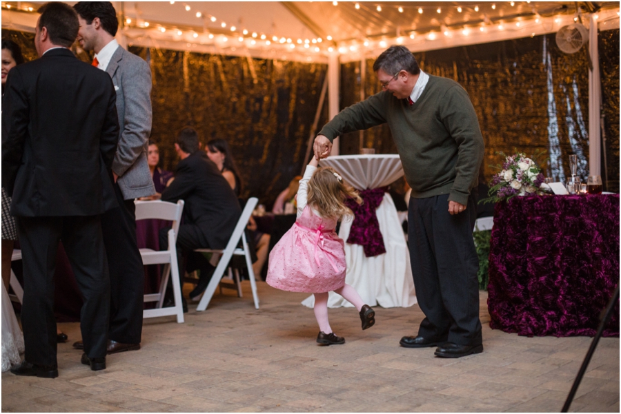 little girl dancing with her daddy at wedding reception