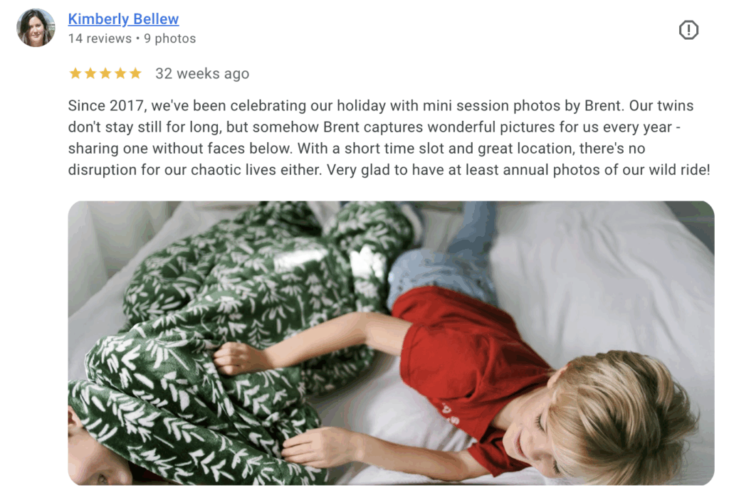 Siblings laughing on holiday bed set at Live View Studios Christmas mini sessions